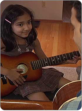 child enjoying advanced private guitar lesson