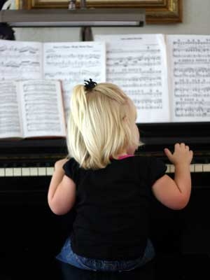 child enjoying in home piano lesson